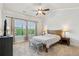 Light and airy bedroom featuring carpeted floors, crown molding, and a large window with green views at 2020 Jardin Ct, Alpharetta, GA 30022