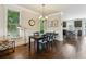 Elegant dining area with dark wood floors and view to kitchen at 2020 Jardin Ct, Alpharetta, GA 30022