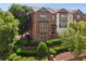 Charming brick townhome with well-maintained landscaping and manicured bushes at 2020 Jardin Ct, Alpharetta, GA 30022