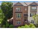 Inviting brick townhome featuring a classic design and manicured front garden at 2020 Jardin Ct, Alpharetta, GA 30022