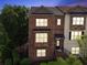 Traditional brick townhome with a well-manicured lawn and covered entryway at 2020 Jardin Ct, Alpharetta, GA 30022