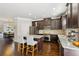 Beautiful kitchen with stainless steel appliances, a granite island, and dark wood cabinets at 2020 Jardin Ct, Alpharetta, GA 30022