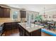 Open kitchen with dark wood cabinets, stainless appliances, granite countertops, and a large island at 2020 Jardin Ct, Alpharetta, GA 30022