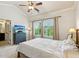 Spacious bedroom with soft carpet, a window with lush green views, and modern ceiling fan at 2020 Jardin Ct, Alpharetta, GA 30022