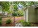 The backyard's landscape includes a stone pathway and arched gateway at 615 Sycamore Dr, Decatur, GA 30030