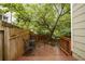 Wooden deck with outdoor seating surrounded by lush greenery and trees at 615 Sycamore Dr, Decatur, GA 30030