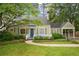 Charming bungalow-style home featuring a blue front door, manicured lawn, and mature landscaping at 615 Sycamore Dr, Decatur, GA 30030