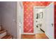 Hallway featuring patterned wallpaper, hardwood floors, and access to a bathroom at 615 Sycamore Dr, Decatur, GA 30030