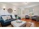 The hardwood-floored living room has neutral decor, lamps, a sofa, and natural lighting at 615 Sycamore Dr, Decatur, GA 30030