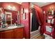 Bathroom showcasing vanity and shower/tub combo with red shower curtain at 7324 Bridlewood Ct, Jonesboro, GA 30236