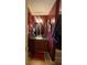 Bathroom with dark cherry vanity, mirror, sink and hanging towels at 7324 Bridlewood Ct, Jonesboro, GA 30236