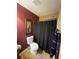 Functional bathroom with a toilet, a shower with curtain, and complementary wall art at 7324 Bridlewood Ct, Jonesboro, GA 30236