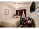 Bedroom featuring neutral tones, ceiling fan, and desk area with computer at 7324 Bridlewood Ct, Jonesboro, GA 30236