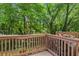 Back deck overlooking a lush, green yard with mature trees at 7324 Bridlewood Ct, Jonesboro, GA 30236