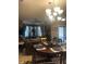 Dining area is adjacent to the living room, with a large chandelier overhead at 7324 Bridlewood Ct, Jonesboro, GA 30236