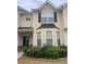 Two-story tan home with black shutters and flowerbeds in front yard at 7324 Bridlewood Ct, Jonesboro, GA 30236