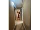 Hallway leading to rooms, with neutral color walls and carpet at 7324 Bridlewood Ct, Jonesboro, GA 30236