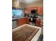 Kitchen featuring stainless steel appliances, granite countertops, and wooden cabinets at 7324 Bridlewood Ct, Jonesboro, GA 30236