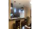 Eat-in kitchen with pendant lights, bar-top counter, and stainless steel appliances at 7324 Bridlewood Ct, Jonesboro, GA 30236