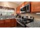 Featuring granite countertops and stainless steel appliances at 7324 Bridlewood Ct, Jonesboro, GA 30236