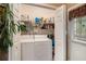 Laundry room with full-sized washer and dryer and shelving for cleaning supplies at 7324 Bridlewood Ct, Jonesboro, GA 30236