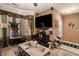 Cozy living room with large TV, neutral walls, decorative plants, and tile entryway at 7324 Bridlewood Ct, Jonesboro, GA 30236