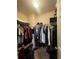 Walk-in closet with ample hanging space, overhead shelving, and storage at 7324 Bridlewood Ct, Jonesboro, GA 30236
