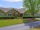 Charming single-story home featuring manicured landscaping, a brick facade, and a well-maintained lawn at 106 Vintage Club Cir, Marietta, GA 30066