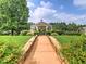 Picturesque gazebo surrounded by lush greenery and vibrant flowers in a serene garden setting at 106 Vintage Club Cir, Marietta, GA 30066