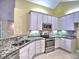 Modern kitchen featuring stainless steel appliances, granite countertops, and white cabinets at 106 Vintage Club Cir, Marietta, GA 30066