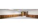 Large basement featuring wood-paneled walls, neutral carpet, and wooden doors at 1440 Northwold Dr, Atlanta, GA 30350