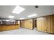 Finished basement featuring wood-paneled walls, a bar area, and ample space for recreation at 1440 Northwold Dr, Atlanta, GA 30350
