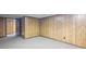 Basement with neutral carpet, wood-paneled walls, and a wooden door at 1440 Northwold Dr, Atlanta, GA 30350