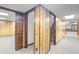 Basement hallway with wood-paneled walls, neutral carpet, and a staircase at 1440 Northwold Dr, Atlanta, GA 30350