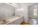Bathroom featuring dual sinks, long mirror, and an open doorway to another room at 1440 Northwold Dr, Atlanta, GA 30350