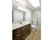 Bathroom featuring an old vanity, patterned wallpaper, and a shower with sliding doors at 1440 Northwold Dr, Atlanta, GA 30350