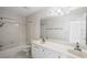 Bright bathroom featuring dual sinks, white cabinetry, a large mirror, and a shower-tub combo at 1440 Northwold Dr, Atlanta, GA 30350