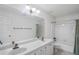 Classic bathroom with dual sinks, tub, and a patterned wallpaper at 1440 Northwold Dr, Atlanta, GA 30350