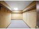 Walk-in closet with neutral carpet, wood-paneled walls, and shelving on either side at 1440 Northwold Dr, Atlanta, GA 30350