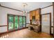 Charming dining area with a built-in desk, wood floors, and large windows overlooking greenery at 1440 Northwold Dr, Atlanta, GA 30350