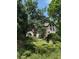Stunning stone and stucco home nestled among mature trees and lush landscaping at 1440 Northwold Dr, Atlanta, GA 30350