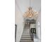 Elegant foyer with marble floors and winding staircase topped by a grand chandelier at 1440 Northwold Dr, Atlanta, GA 30350