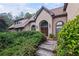 Charming front entrance with stone and stucco finishes and a wooden walkway at 1440 Northwold Dr, Atlanta, GA 30350