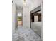 Bright hallway with marble tile flooring leading to a sunroom and living spaces at 1440 Northwold Dr, Atlanta, GA 30350