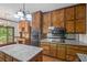 Spacious kitchen featuring wood cabinets, granite counters, and modern stainless appliances at 1440 Northwold Dr, Atlanta, GA 30350