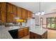 Bright kitchen features wood cabinets, granite counters, an island, and a garden view at 1440 Northwold Dr, Atlanta, GA 30350