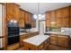 Spacious kitchen featuring granite countertops, wood cabinetry, and built-in appliances at 1440 Northwold Dr, Atlanta, GA 30350