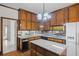 Traditional kitchen with wooden cabinets, granite countertops, and a central island at 1440 Northwold Dr, Atlanta, GA 30350