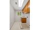 Functional laundry room with vintage wood cabinets, utility sink, and tile flooring at 1440 Northwold Dr, Atlanta, GA 30350