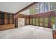 Bright living room featuring wood paneling, built-in shelving, and large windows with views at 1440 Northwold Dr, Atlanta, GA 30350